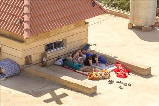 Photo taken of four young men sleeping on the roof of a church in Erbil on the morning of August 17 2014.